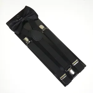 Close-up of black satin bowtie and elastic suspenders set on display card with metal clips