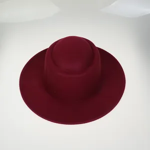 Top view of a high-quality deep red wool felt fedora hat with a wide flat brim