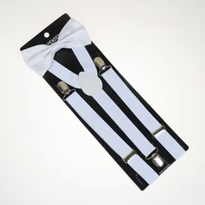 Macro view of white elastic suspenders with silver metal clips and matching bow tie set
