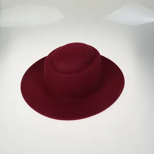 Close-up of burgundy wool felt boater hat showing fine texture and wide brim stitching