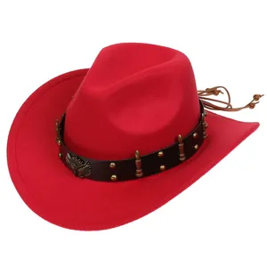 Close-up of red felt cowboy hat featuring a black leather band with golden eagle and bullet charms