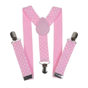 Detail view of pink polka dot Y-back suspenders with elastic straps and silver metal clips