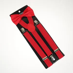 Macro shot of red satin bowtie and elastic suspenders set with silver metal clips