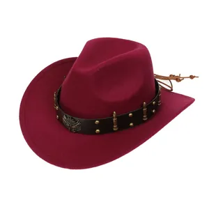 Detail of burgundy wide-brim cowboy hat with leather band, eagle emblem and studs