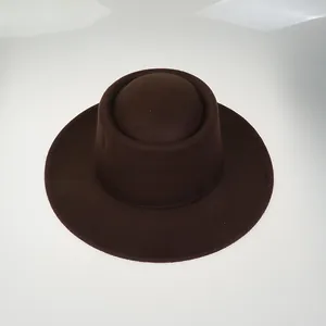 Detail view of the wide-brim dark brown felt hat with textured wool-like material