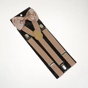 Detail of champagne gold elastic Y-back suspenders with metallic clips and satin bowtie