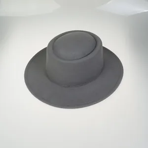 Detailed close-up of dark grey flat-top wool boater hat with smooth felt texture