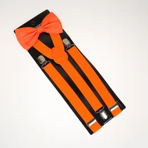 Detail view of vibrant orange bow tie and elastic suspenders set with silver metal clips