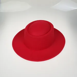 Detail shot of a bright red flat-top wool felt fedora with a smooth textured wide brim