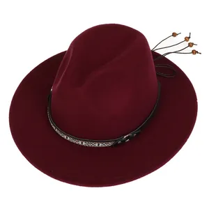 Close-up of burgundy wool fedora featuring an ethnic patterned band and wooden bead charms