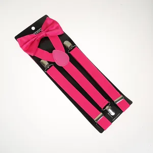 Detail of hot pink elastic suspenders and bowtie set with silver metal clips on a card