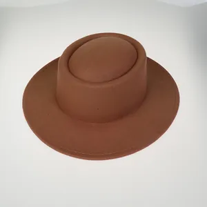Detail of high-quality brown wool felt flat top hat with fine stitching on the brim