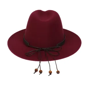 Detail of wool fedora hat in burgundy with black leather band and wooden bead charms