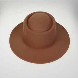 Top-down view of a thick brown felt flat-top hat with a unique cylindrical crown design