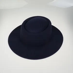Top view of a minimalist navy blue flat top wool felt hat with a wide stiff brim