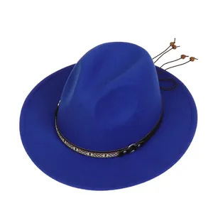 Detail of blue wool fedora with woven geometric band, silver ring, and beaded tassels