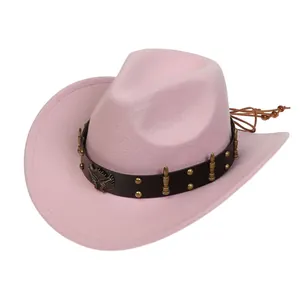 Detail of pink felt cowboy hat with leather band, eagle badge and golden bullet studs