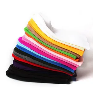 Detailed stack of multi-color knitted beanies showing soft fabric texture and thickness