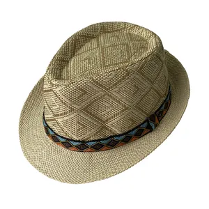 Macro detail of men's trilby straw hat showing intricate woven patterns and ethnic ribbon