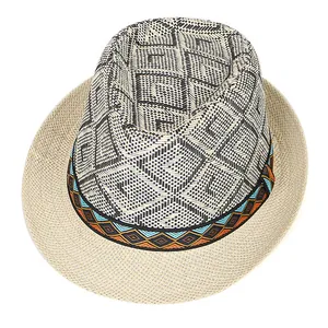 Detail of retro straw fedora featuring ethnic embroidery band and black geometric weave
