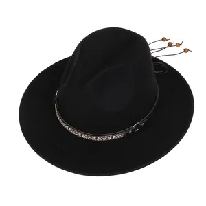 Detail of black wool fedora hat featuring ethnic ribbon with wooden beads and metal buckle
