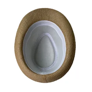 Detailed interior of vintage straw fedora hat showing white sweatband and grey fabric lining