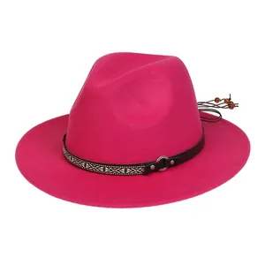 Detail of rose red fedora wool hat featuring ethnic woven band and leather strap decor