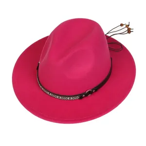 Detail of rose red wool jazz hat featuring ethnic pattern band and wooden bead tassels
