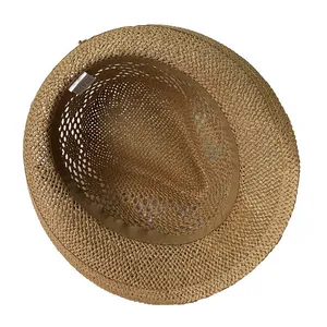 Internal detail of a light brown paper straw sun hat featuring a sweatband and product label