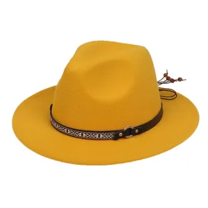 Detail of yellow wool fedora with brown leather band and geometric woven strap accents