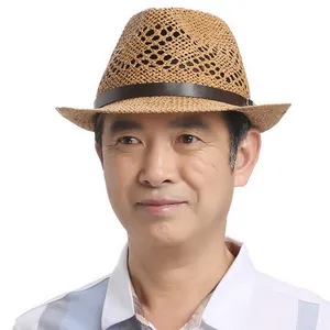 Detail of breathable woven straw jazz hat with brown leather buckle band for sun protection