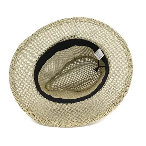 Detail of woven paper fiber texture and black inner sweatband on Panama straw hat