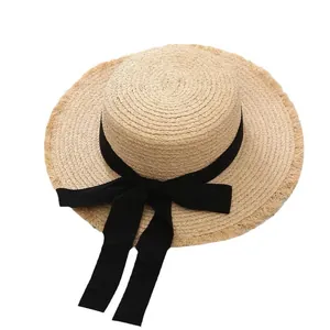 Elegant wide brim raffia sun hat with black ribbon bow for summer beach vacation