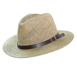 Close-up of woven straw Panama hat with dark brown leather band and silver metal buckle