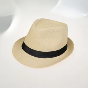 Détail rapproché de la texture du chapeau de paille avec ruban noir et tissage fin