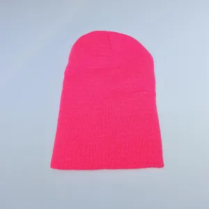 Detail of hot pink beanie showing soft knit texture and ribbed fabric patterns