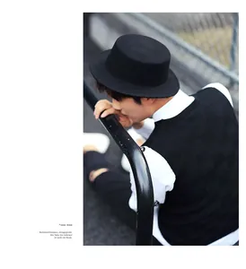 Classic black wool flat-brim fedora styled with a casual urban vest and white shirt outfit