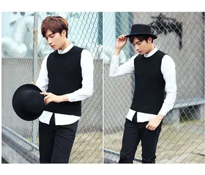 Detail view of a men's black knit vest styled with a fedora hat and white shirt