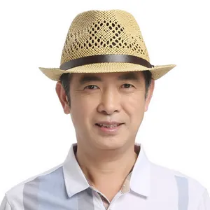 Close-up of a men's breathable straw jazz hat with hollow weave and brown leather band