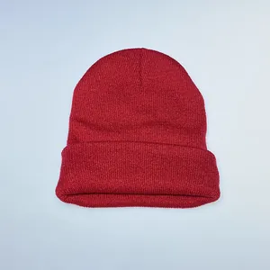 Close-up of vibrant red knit texture and cuffed edge of this winter beanie hat