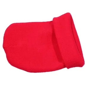 Close-up of red winter beanie showing detailed ribbed knit texture and wide folded cuff