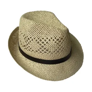 Detail of breathable hollow weave and black ribbon on a classic straw fedora sun hat
