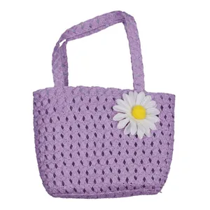 Detail of purple woven straw handbag with white daisy flower for kids beach vacation