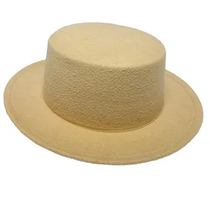 Top-down view of a classic beige flat top wide brim wool fedora hat for men and women