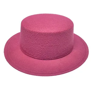 Detail shot of fuchsia wool boater hat featuring a flat top and matching decorative band