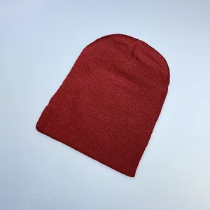 Detailed close-up of dark red ribbed knit texture on a warm winter beanie hat