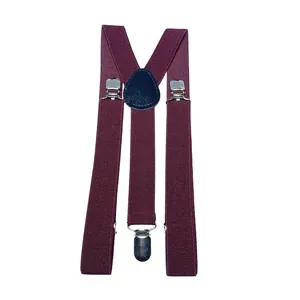 Dettaglio delle bretelle a Y bordeaux con robuste clip in metallo argento e nastro elastico