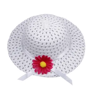 Detail of white hollow woven straw hat with purple daisy flower and satin ribbon