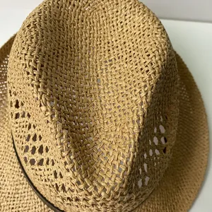 Detailed macro view of the breathable hollow woven texture on a straw jazz hat