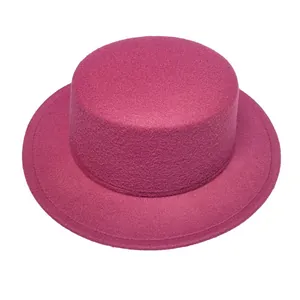 Detail of a bright magenta flat top wool felt hat with a vintage wide brim design